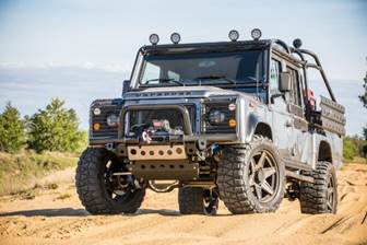 A vehicle on a dirt road

Description automatically generated